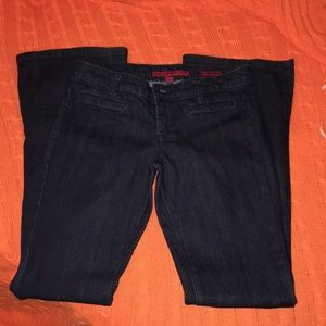 Dark denim flare jeans with small front pockets.